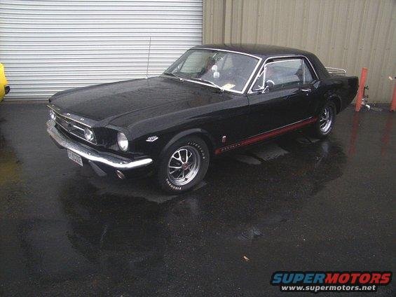 Black 1965 Mustang coupe with red side stripe
