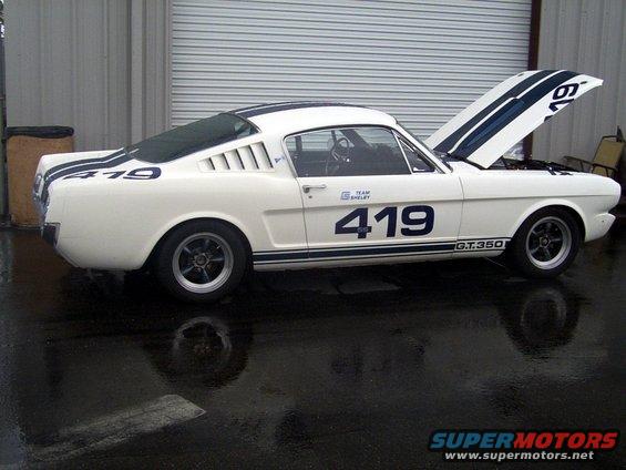 White 1965 Shelby GT350 race car, number 419, with blue stripes and hood open