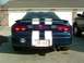 1995 Ford Probe - Rear view of a blue 1995 Ford Probe GT white racing stripes and a spoiler.