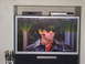 1990 Ford Bronco - A television displays a scene with a man wearing sunglasses and a leather jacket.
