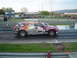 1999 Ford Crown Victoria - A red Dodge Magnum station wagon, labeled as a 2005 Cannonball Run race vehicle, is on a drag strip with various sponsor decals.