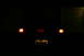 1995 Ford Probe - The rear of a car is visible at night, with its taillights illuminated and a GT emblem on the trunk.
