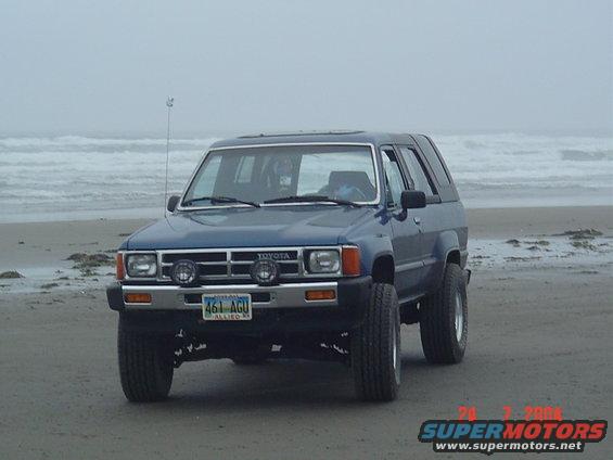 Blue Toyota 4Runner on a beach, front view. License plate 461 AGU