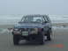 1988 Ford Ranger - A blue Toyota 4Runner is parked on a sandy beach with the ocean in the background.