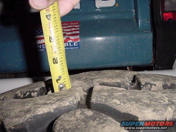 Measuring tire tread depth on a vehicle with a tape measure