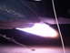 1988 Ford Bronco - The bright exhaust of a jet engine is visible, with a metal rod and cable nearby.
