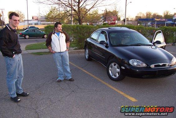 Black 1998 Mercury Sable sedan parked with driver's door open
