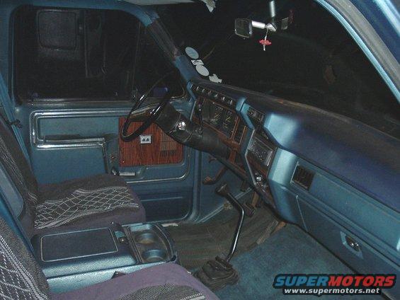 Blue truck interior with wood trim and bench seat