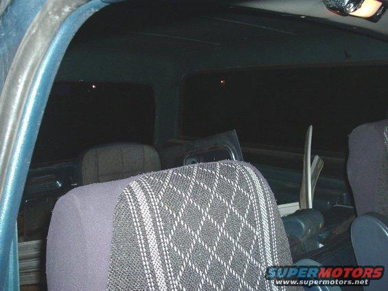 Interior view of a vehicle with patterned seat fabric and dark windows