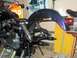 1976 Harley-Davidson Super Glide - A purple motorcycle's rear fender and engine are visible while it is supported on a stand in a garage setting.