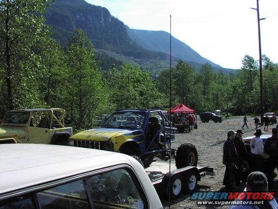 Blue and yellow off-road buggy on trailer, front view