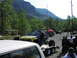 1993 Ford Bronco - An off-road buggy with a blue and yellow paint scheme is loaded onto a trailer at an outdoor event.
