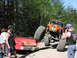 1993 Ford Bronco - An off-road buggy is being pulled out of a ditch by a red pickup truck in a wooded area.