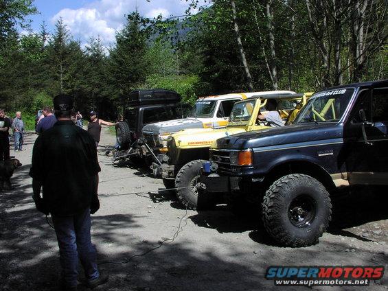 1993 Ford Bronco and other off-road vehicles parked in a line outdoors