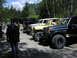 1993 Ford Bronco - Several off-road vehicles, including a 1993 Ford Bronco, are parked together on a dirt road.