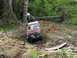 1993 Ford Bronco - A red SUV tackles a challenging off-road path, with another Jeep visible further up the trail.