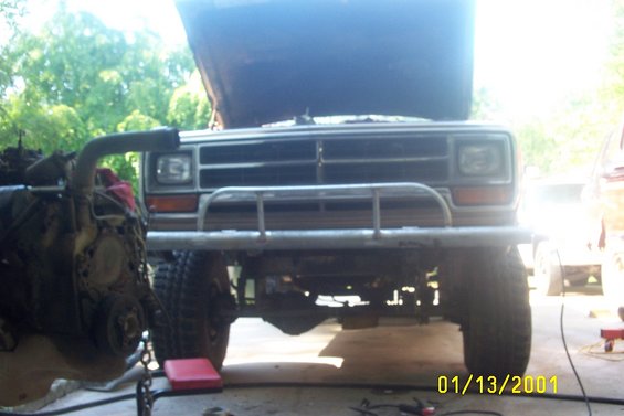 1979 Ford F-150 front view with hood open, aftermarket bumper, and engine removed