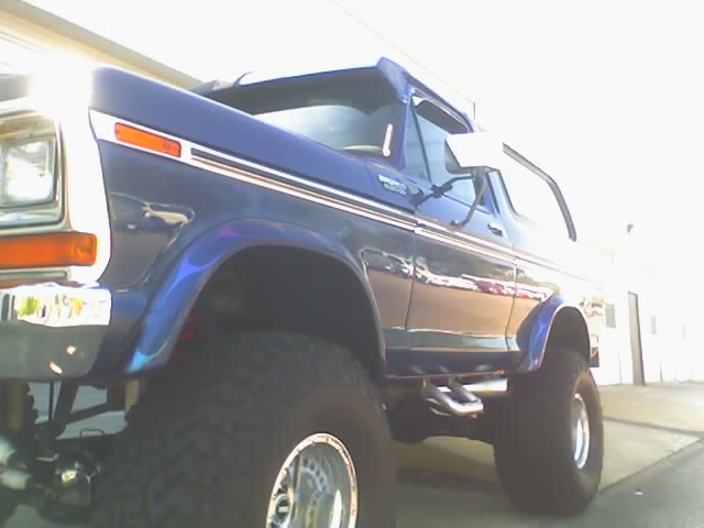 Lifted blue 1978 Ford Bronco, front quarter view