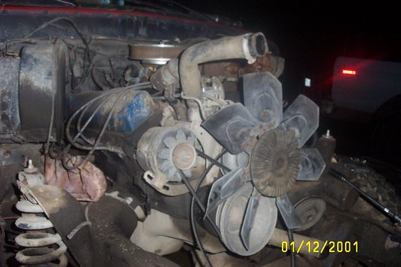 Engine bay with fan, belts, and hoses visible. Date stamp reads 01/12/2001