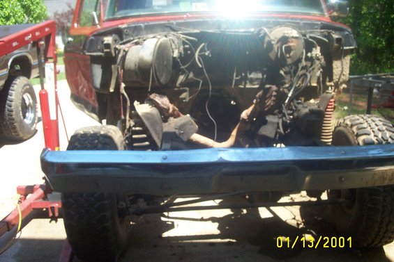 1979 Ford F-150 engine bay with front bumper and tires visible, another truck in background