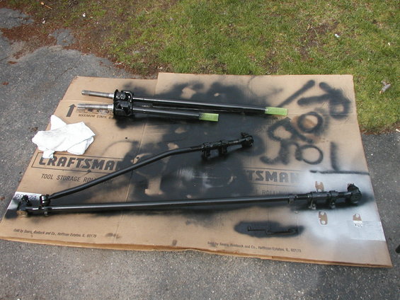 Black steering linkage parts on a Craftsman box