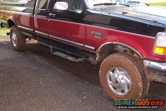 Mud-covered Ford F-250 pickup truck, side view. "F250" badge visible