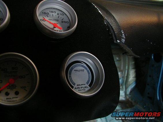 Close-up of dashboard gauges including an air/fuel ratio meter and a fuel pressure gauge