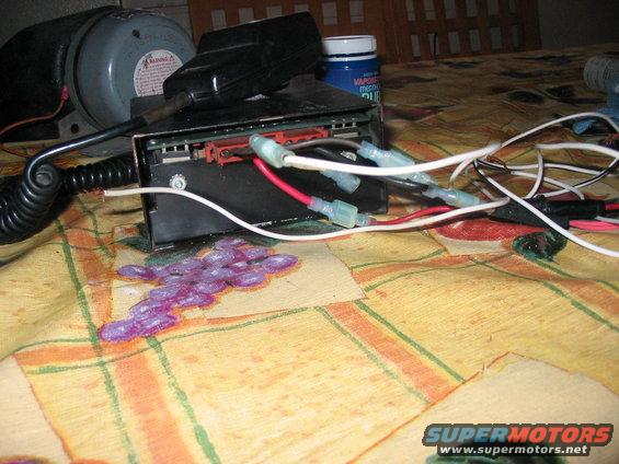 Electronic device with red and white wires connected, on a patterned cloth surface