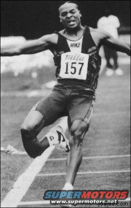 Runner number 157 crosses finish line, Nike logo visible