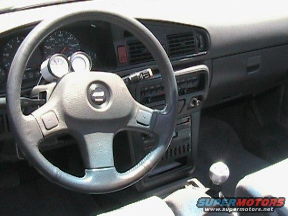 Car interior with aftermarket gauges and a manual shifter