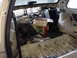 1998 Volkswagen Jetta - The interior of a car is shown with its components removed, revealing exposed wiring and a box of cat litter.