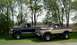 1979 Ford F-250 - Two Ford pickup trucks are parked side-by-side on a grassy lawn with trees in the background.