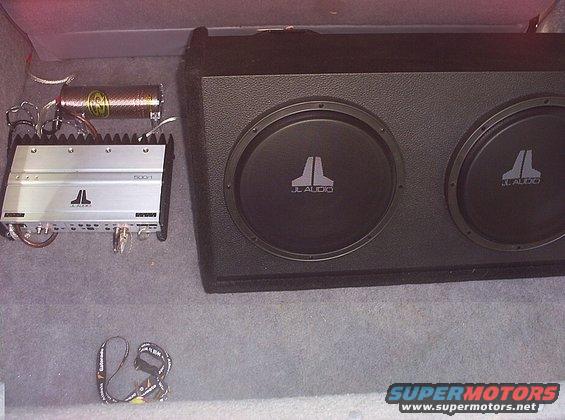 JL Audio amplifier and dual subwoofer box in car trunk