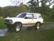 1991 Mazda Navajo - This lifted SUV is parked on a wet driveway with trees in the background.