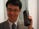 1990 Ford Bronco - Man holds a vintage brick cell phone, a relic from early mobile communication technology.