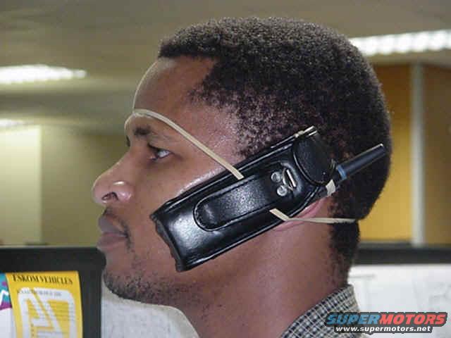 Man wearing a walkie-talkie attached to his head with rubber bands