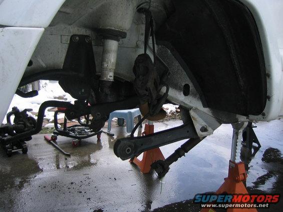 Front suspension components of a 1997 Jeep Cherokee, jack stands supporting the frame
