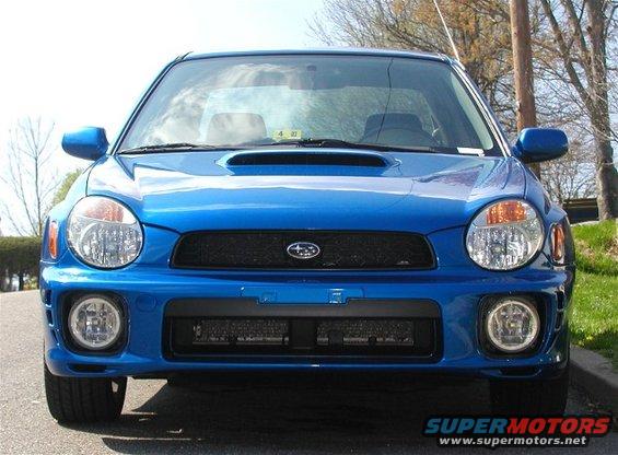 Front view of a blue 2002 Subaru Impreza WRX with a hood scoop and fog lights