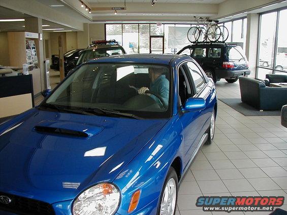 Blue 2002 Subaru Impreza WRX in dealership showroom