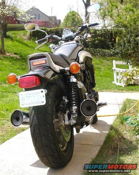 1999 Yamaha V-Max motorcycle, rear view, dark color, parked on sidewalk