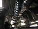 1994 Ford Bronco - Underside view of a vehicle's suspension system, showing the coil spring and shock absorber.