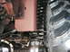 1994 Ford Bronco - A detailed view of a vehicle's undercarriage, focusing on the suspension system and a large tire.