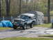 1994 Ford Bronco - A lifted two-tone Ford Bronco is parked in a driveway next to a shed.