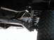 1994 Ford Bronco - Close-up of vehicle undercarriage, focusing on suspension components and tire.