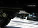 1994 Ford Bronco - Undercarriage view of a vehicle, with another car in the background.