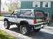 1994 Ford Bronco - This 1994 Ford Bronco is parked in a driveway with a house in the background.