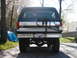 1994 Ford Bronco - The rear of a Ford Bronco shows its spare tire carrier and chrome bumper.