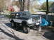 1994 Ford Bronco - A lifted Ford Bronco is parked on concrete blocks in a driveway, with a residential house in the background.