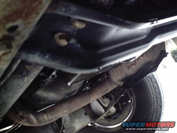 Underside view of vehicle exhaust and tire