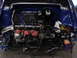 1998 Volkswagen Jetta - The engine bay of a 1998 Volkswagen Jetta is shown with the engine removed, revealing the internal components and wiring.